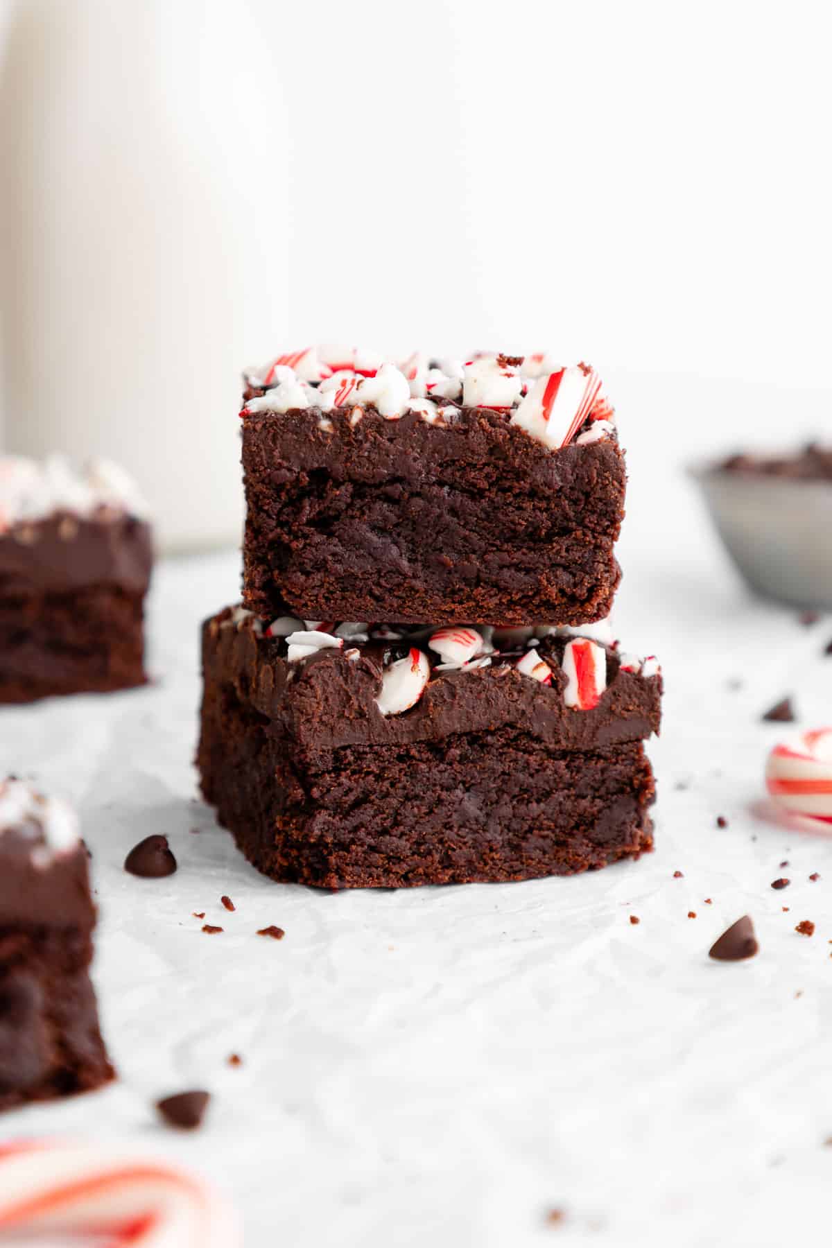 a stack of two vegan peppermint brownies with crushed candy canes