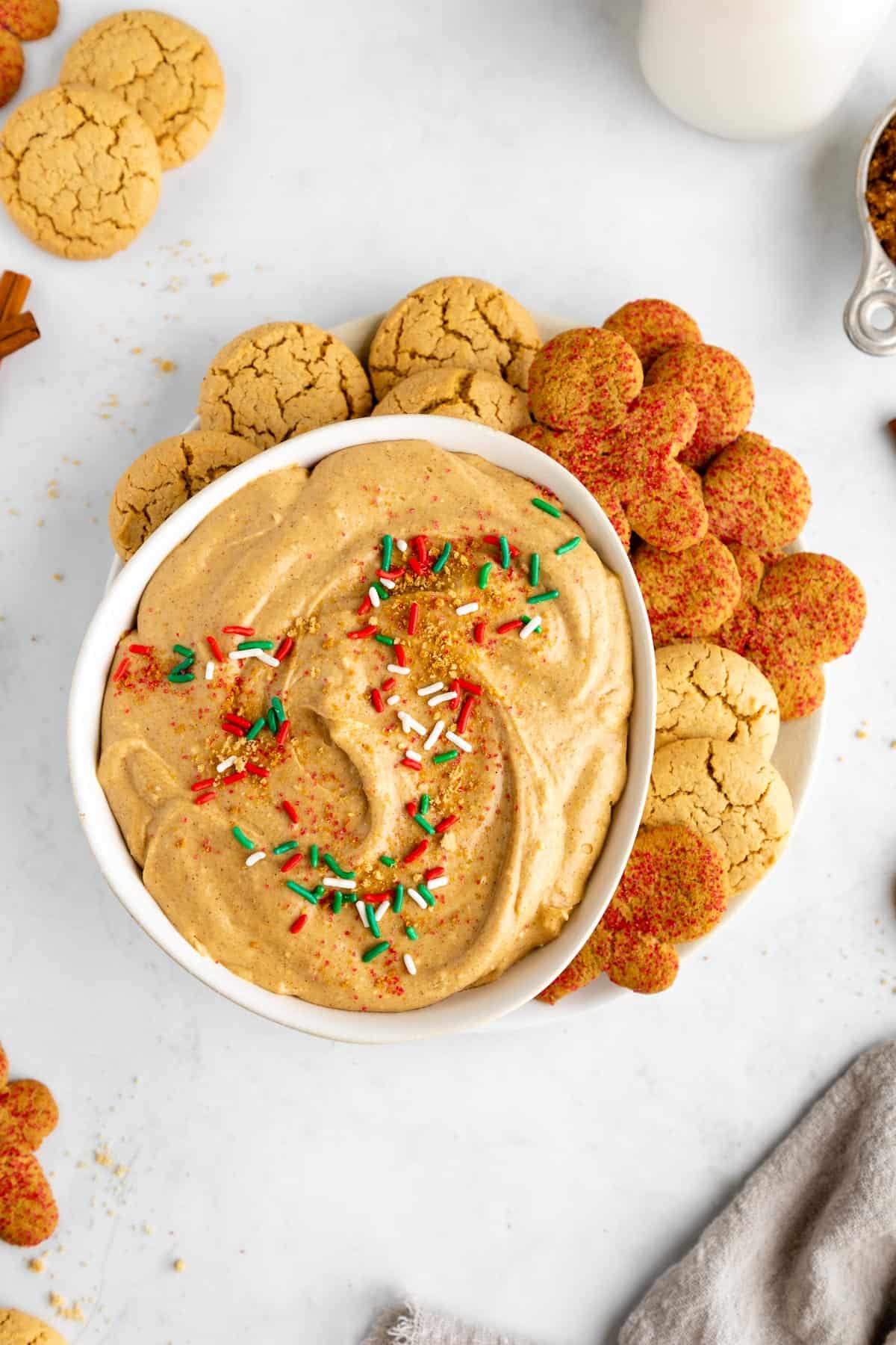 vegan gingerbread cookie dip in a bowl with a plate of ginger snap cookies