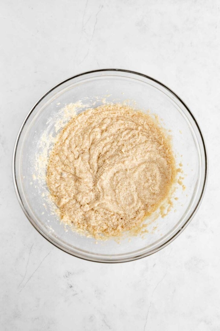 creamed vegan butter, sugar, almond milk, and vanilla extract in a glass mixing bowl