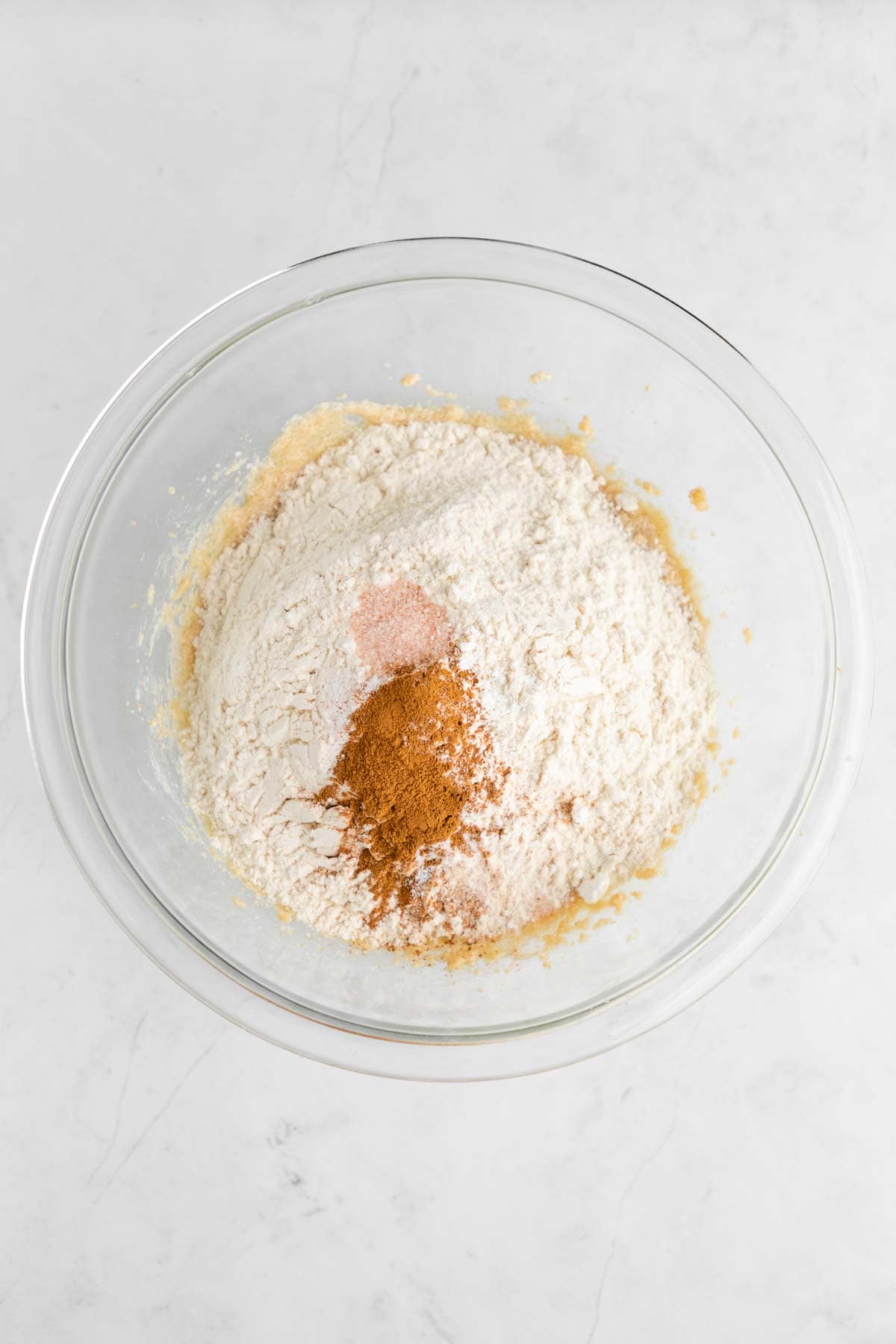 ingredients for vegan cinnamon roll blondies in a glass mixing bowl
