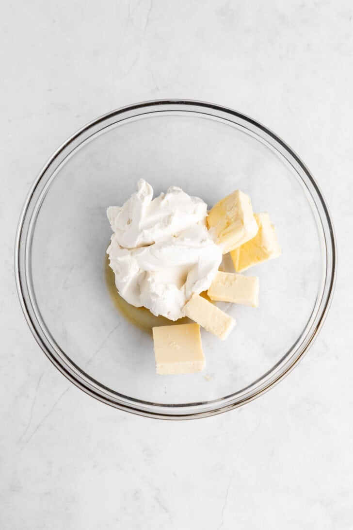 vegan butter, vegan cream cheese, and vanilla extract inside a glass mixing bowl