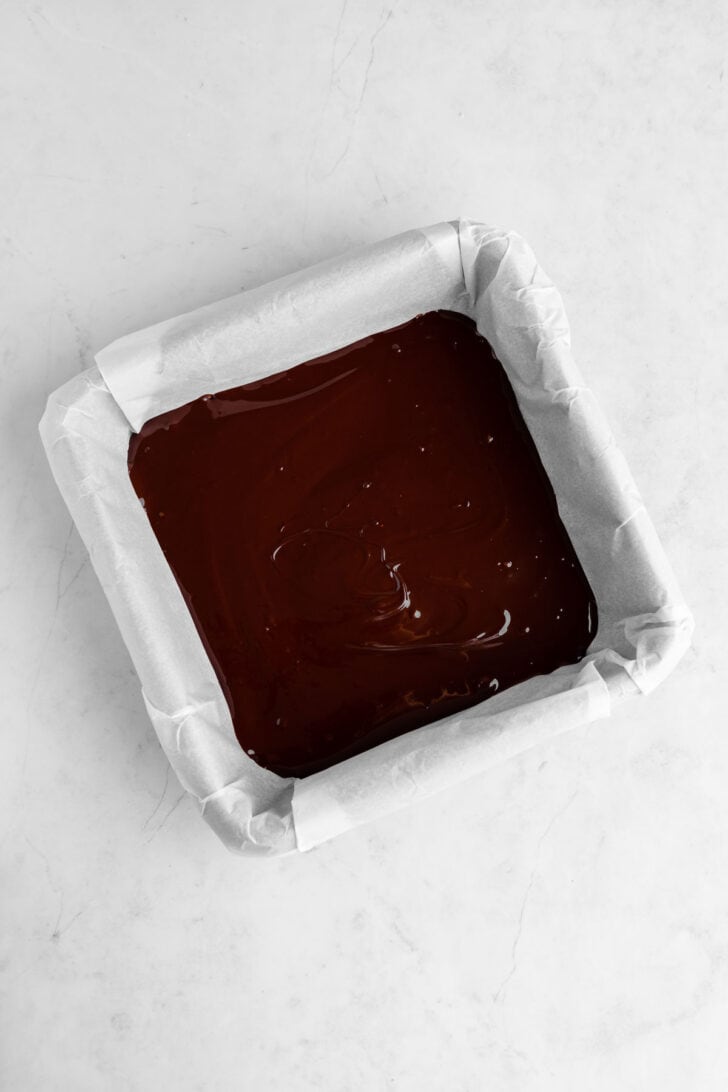 melted vegan dark chocolate in a square baking dish