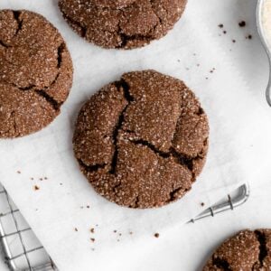 a close up of vegan chocolate sugar cookies on a wire cooling rack