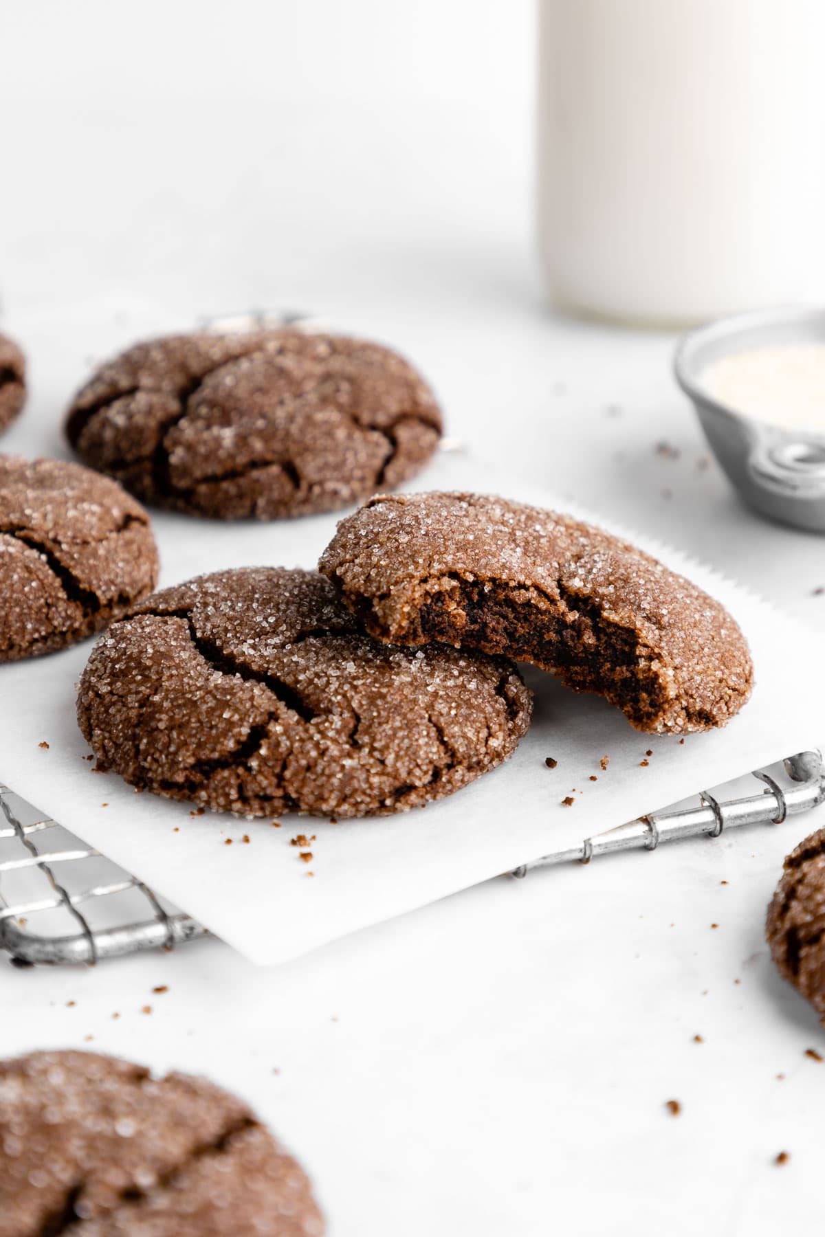 a pile of vegan chocolate sugar cookies with a bite taken out of one