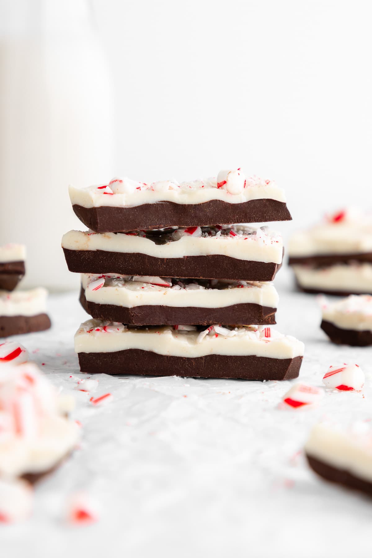 a stack of chocolate vegan peppermint bark with candy canes