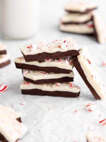 a pile of chocolate vegan peppermint bark with candy canes