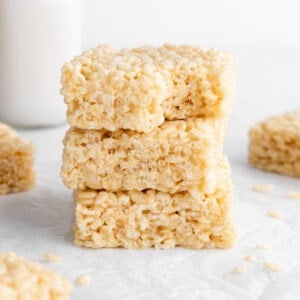 a stack of three vegan rice krispie treats with a bite taken out of the top one
