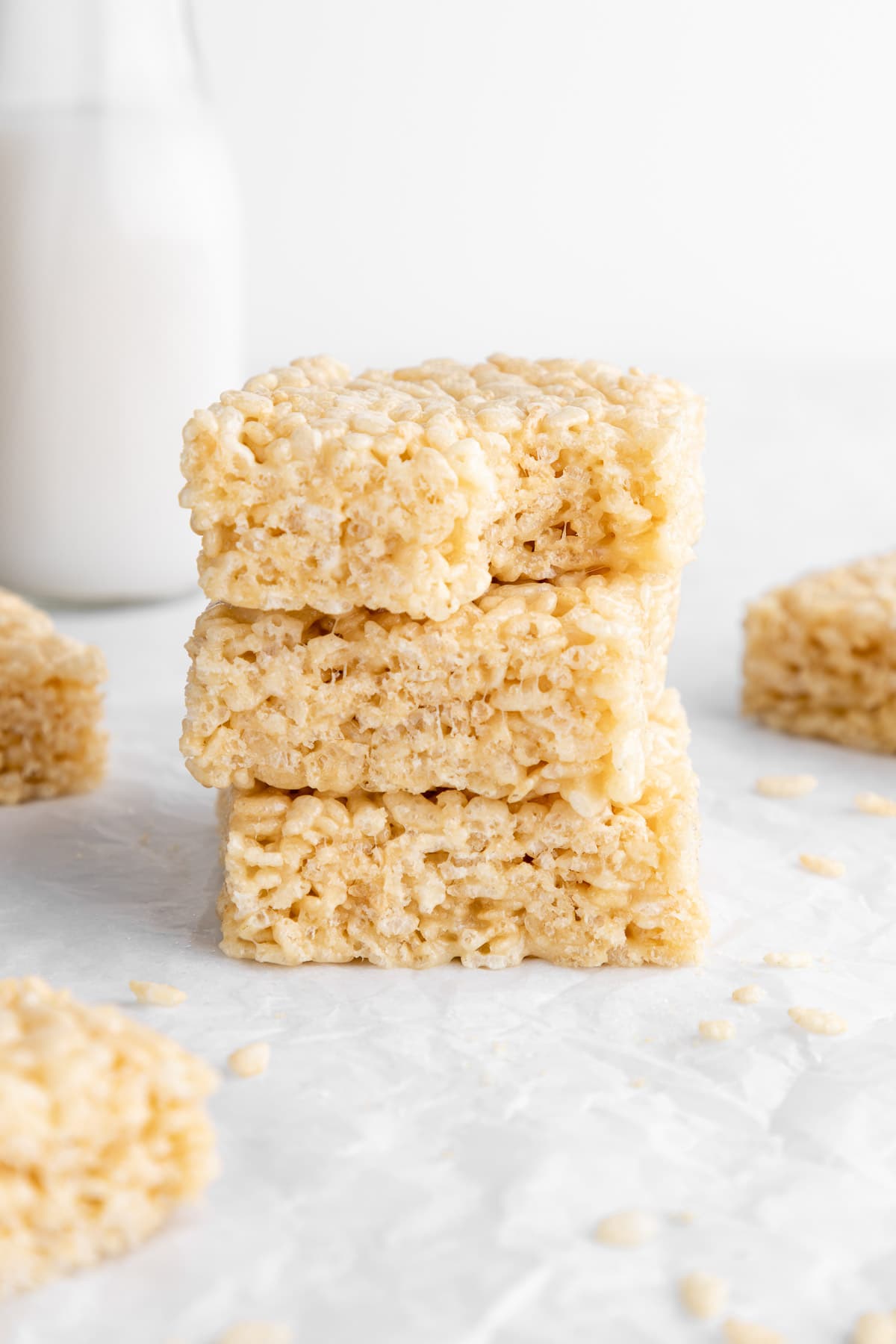 a stack of three vegan rice krispie treats with a bite taken out of the top one