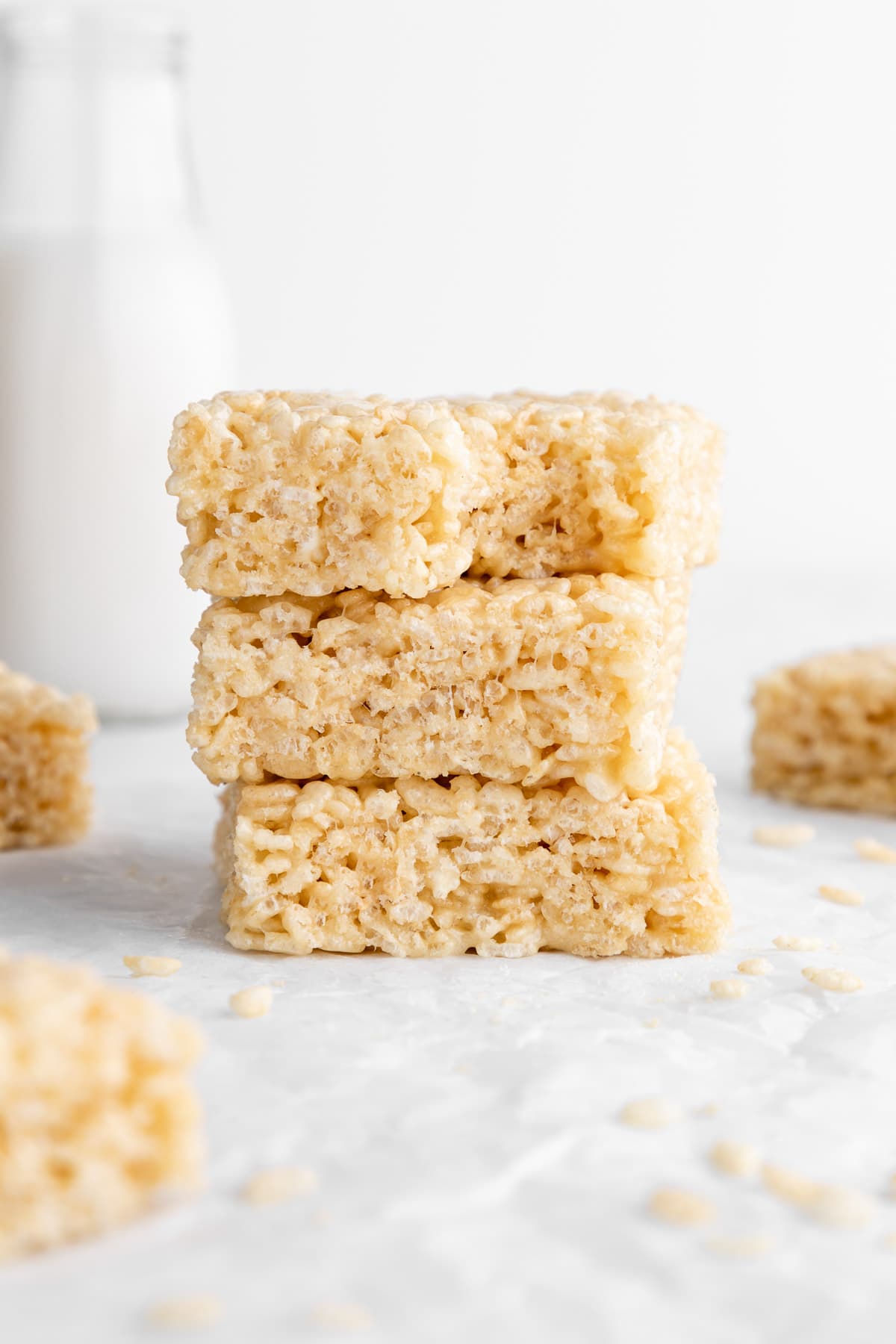a stack of three vegan rice krispie treats with a bite taken out of the top one