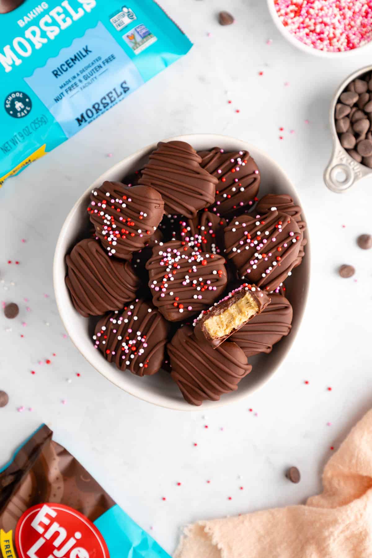 chocolate covered sunbutter hearts inside a bowl with enjoy life chocolate chips