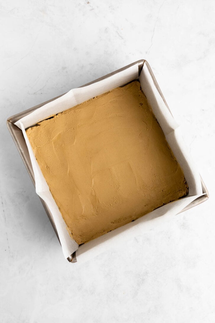 sunflower butter dough pressed inside a square baking pan