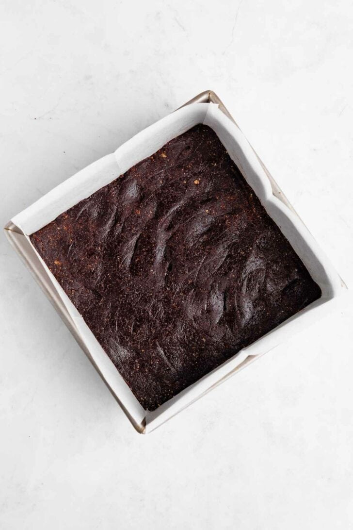 no-bake brownies pressed inside a square baking pan