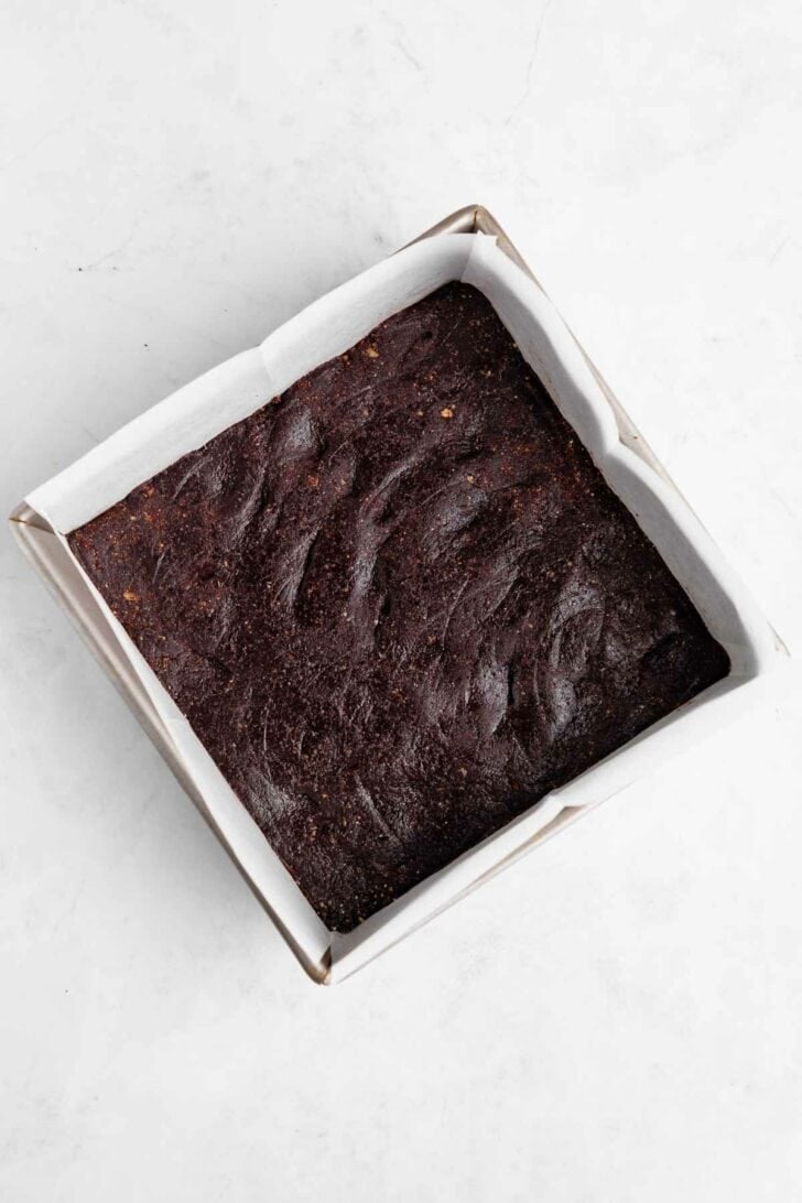 no-bake brownies pressed inside a square baking pan