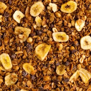 close up photo of homemade chunky monkey granola with banana chips, nuts, coconut, and chocolate chips
