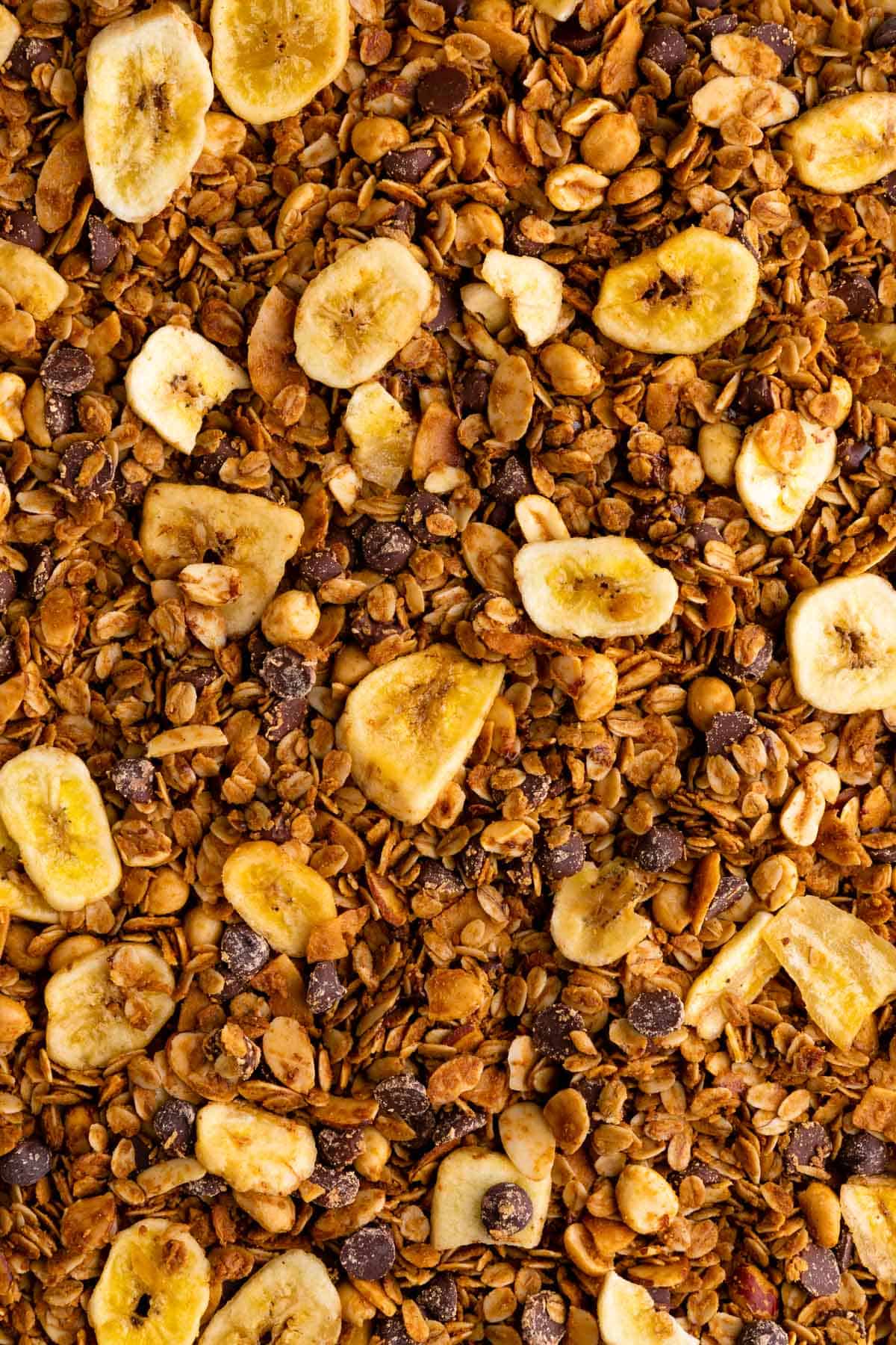 close up photo of homemade chunky monkey granola with banana chips, nuts, coconut, and chocolate chips