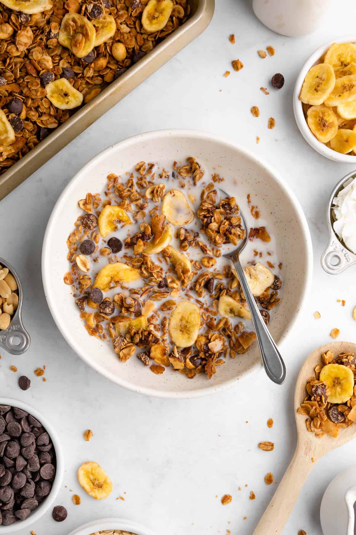 homemade chunky monkey granola in a bowl with banana chips, nuts, coconut, and chocolate chips