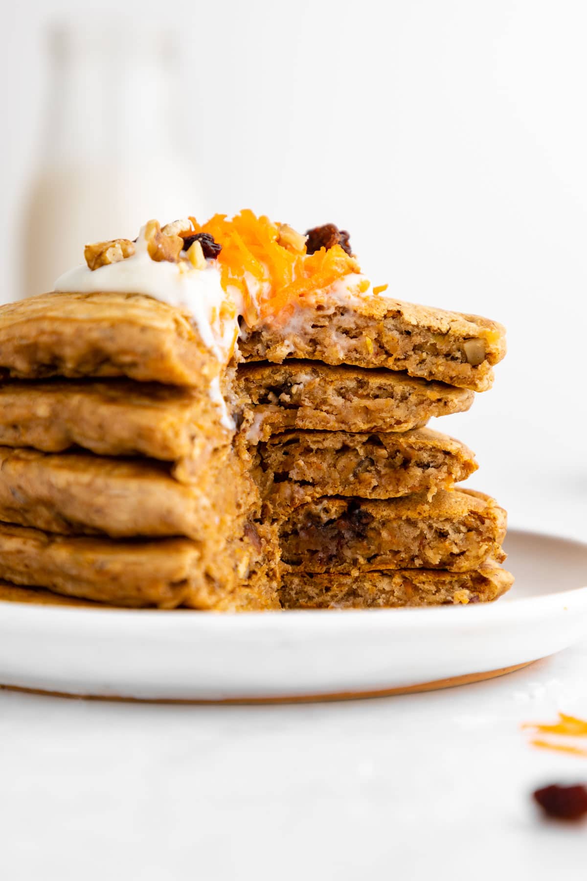 a close up cross section of a stack of vegan carrot cake pancakes