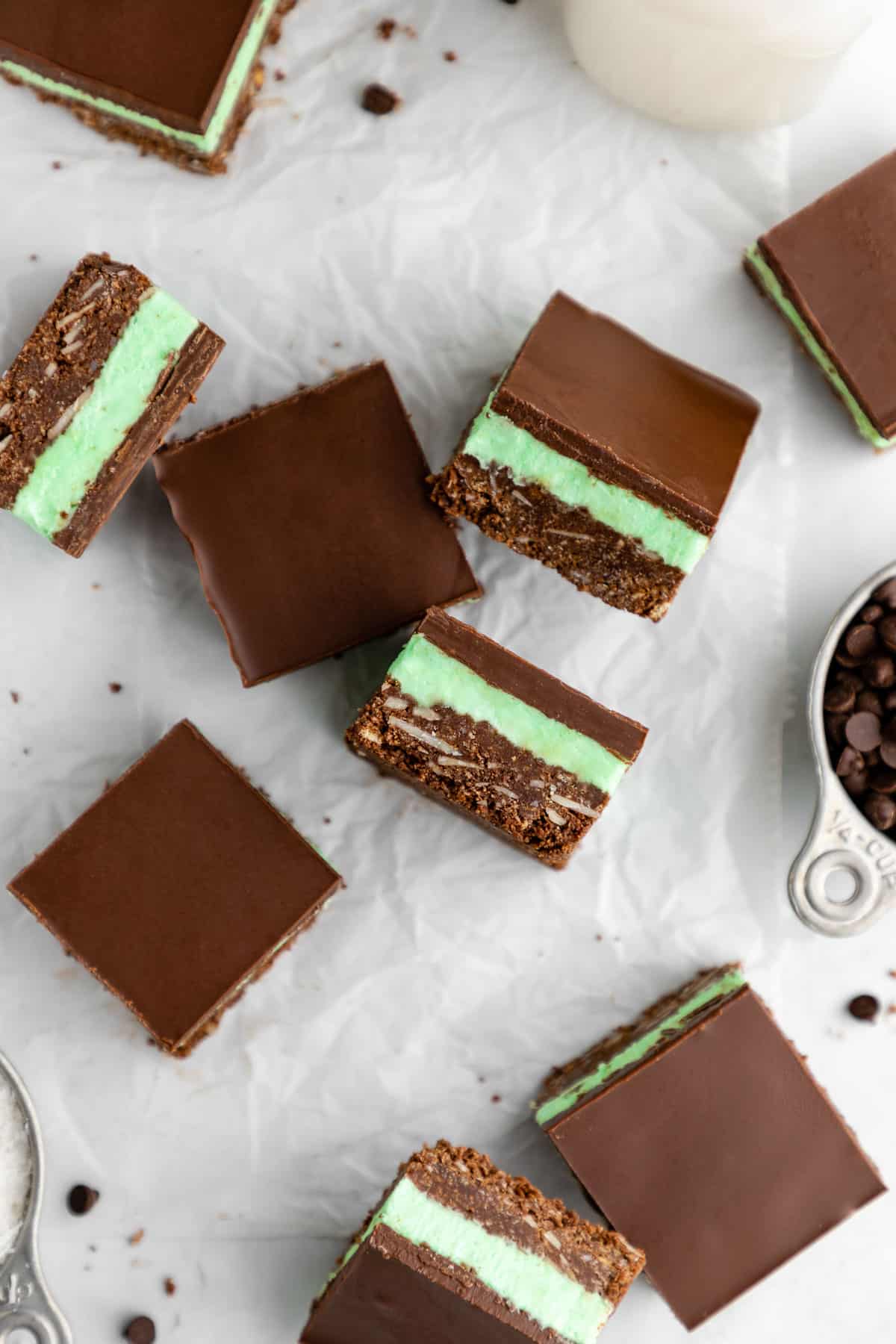 a pile of vegan mint nanaimo bars with mint buttercream frosting and chocolate ganache
