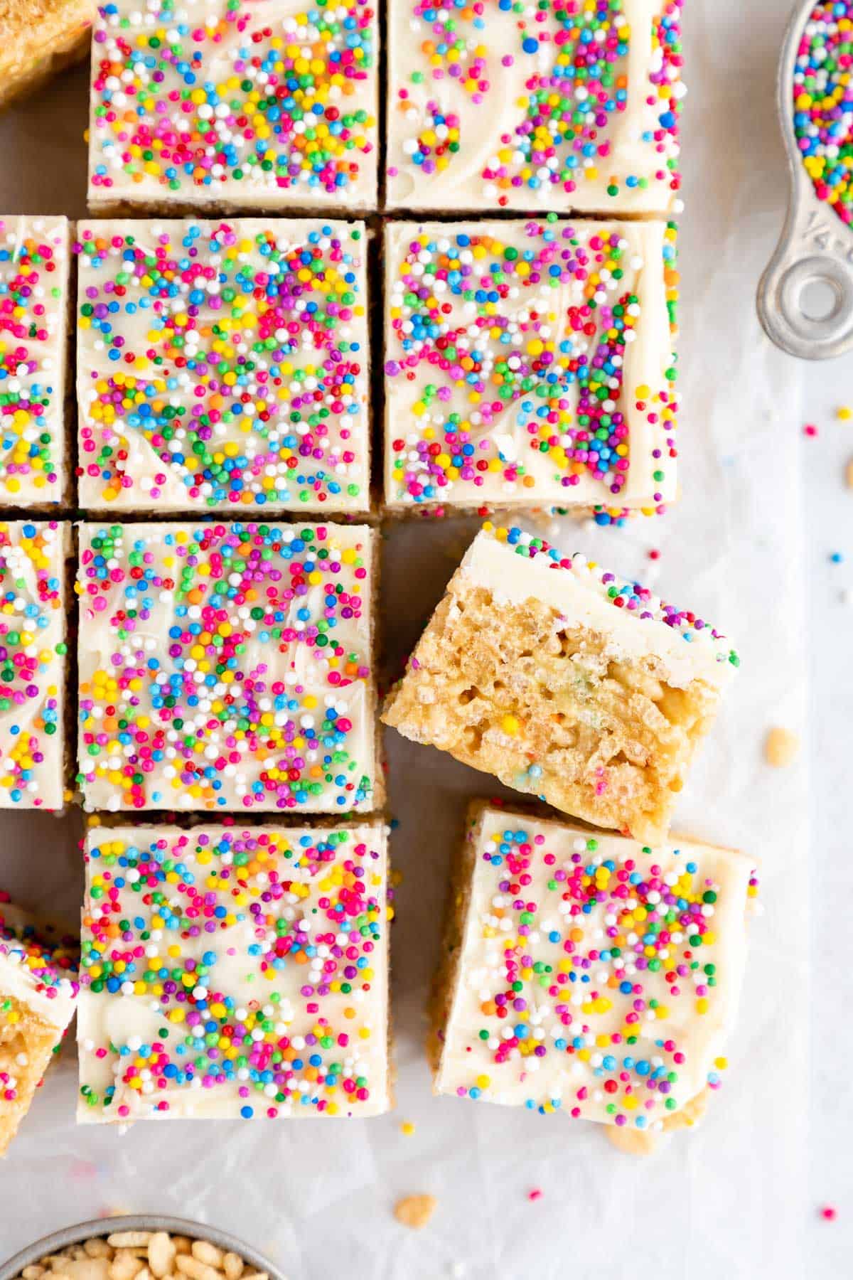 a pile of birthday cake rice krispie treats with white chocolate and sprinkles on top