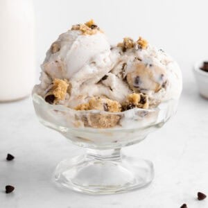 vegan cookie dough ice cream scoops inside a sundae glass