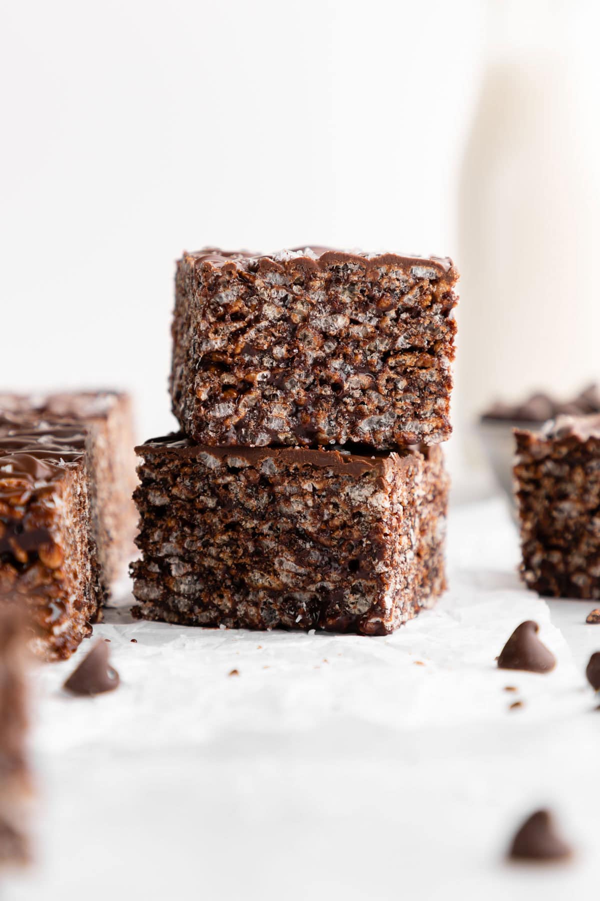 two vegan chocolate rice krispie treats with chocolate chips stacked on top of each other