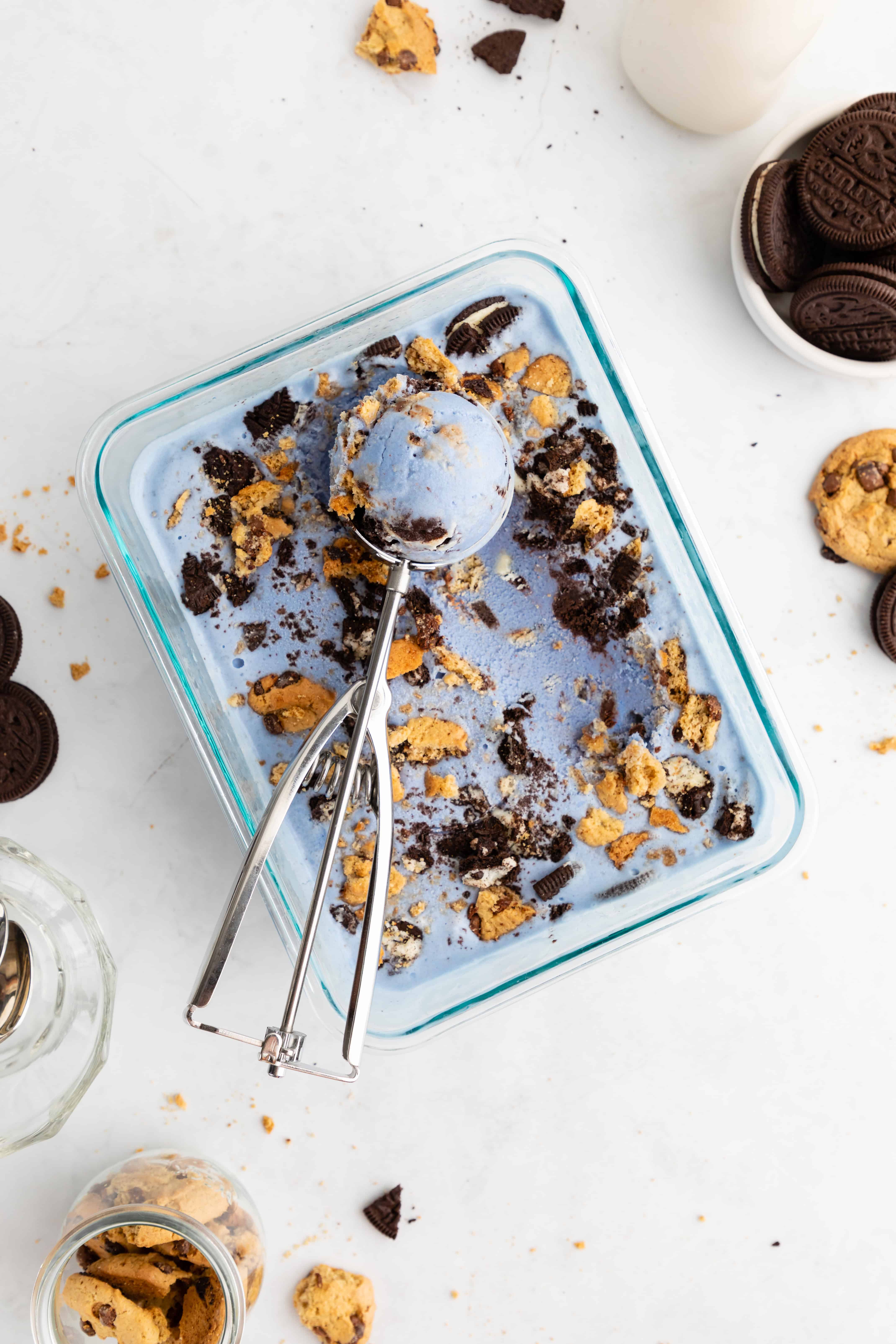 an ice cream scoop scooping into a container of homemade vegan cookie monster ice cream
