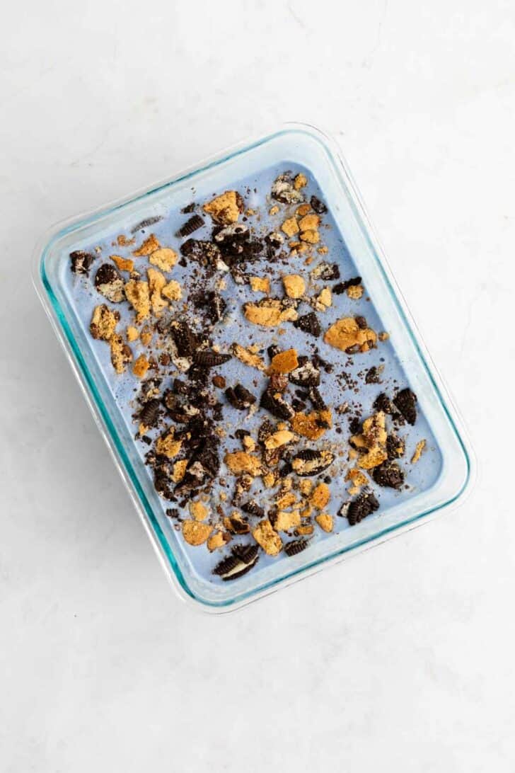 homemade vegan cookie monster ice cream inside a glass bowl with oreos and chocolate chip cookies