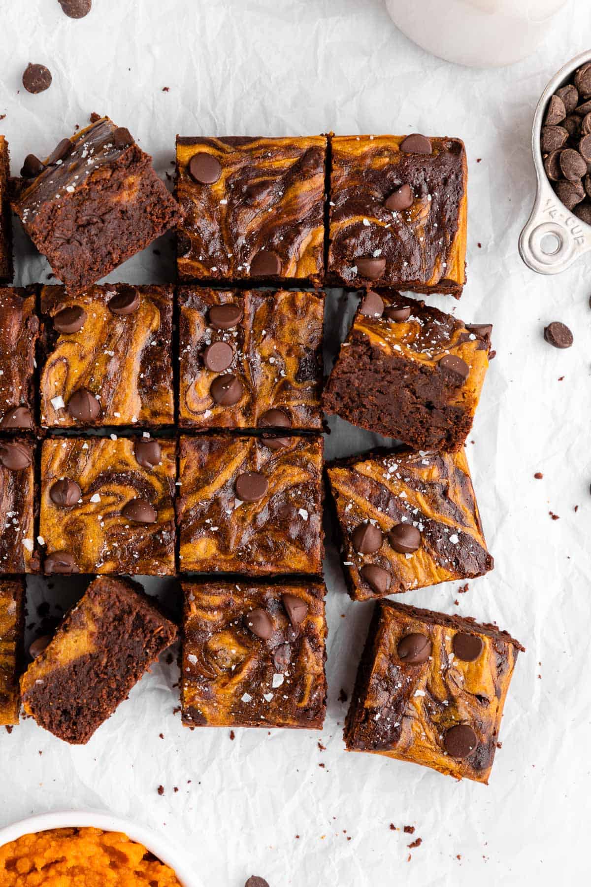 a pile of sliced vegan pumpkin cheesecake brownies