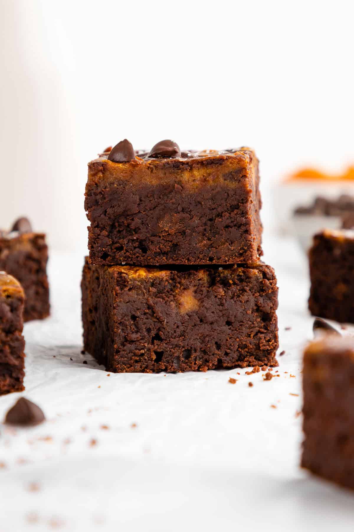 a stack of vegan pumpkin cheesecake brownies
