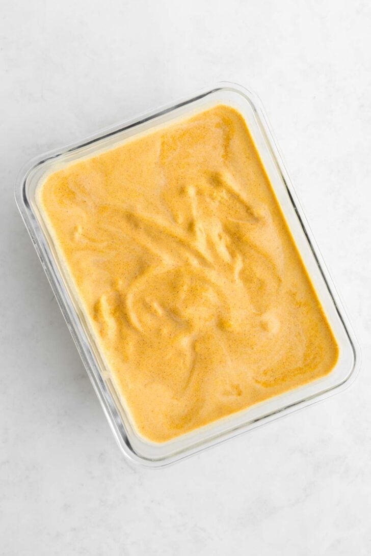 vegan pumpkin ice cream inside a pyrex glass container