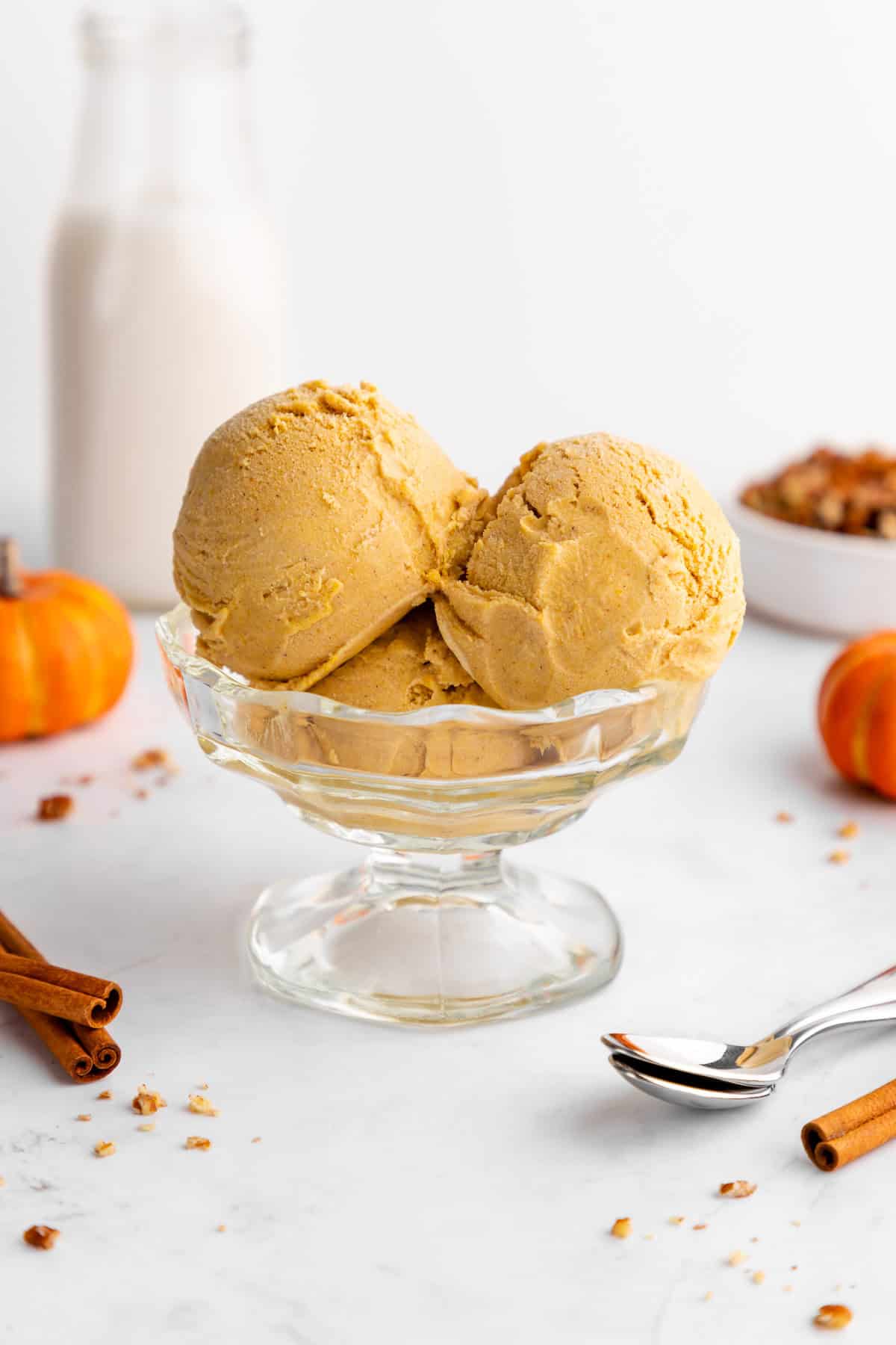 scoops of vegan pumpkin ice cream inside a glass sundae bowl