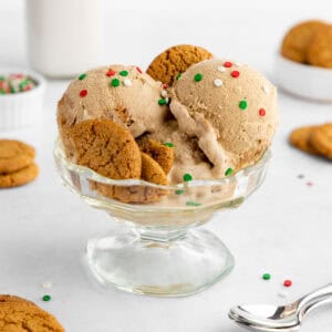 scoops of vegan gingerbread ice cream with gingersnap cookies inside a sundae glass