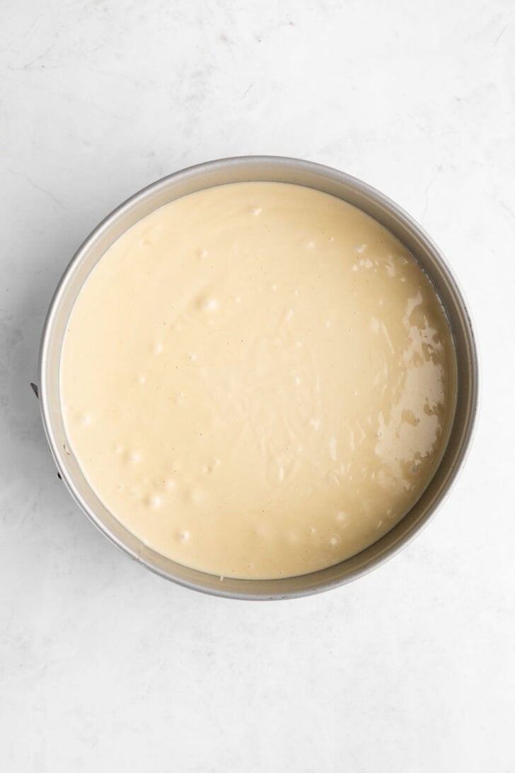 no-bake vegan cheesecake filling inside a cake pan
