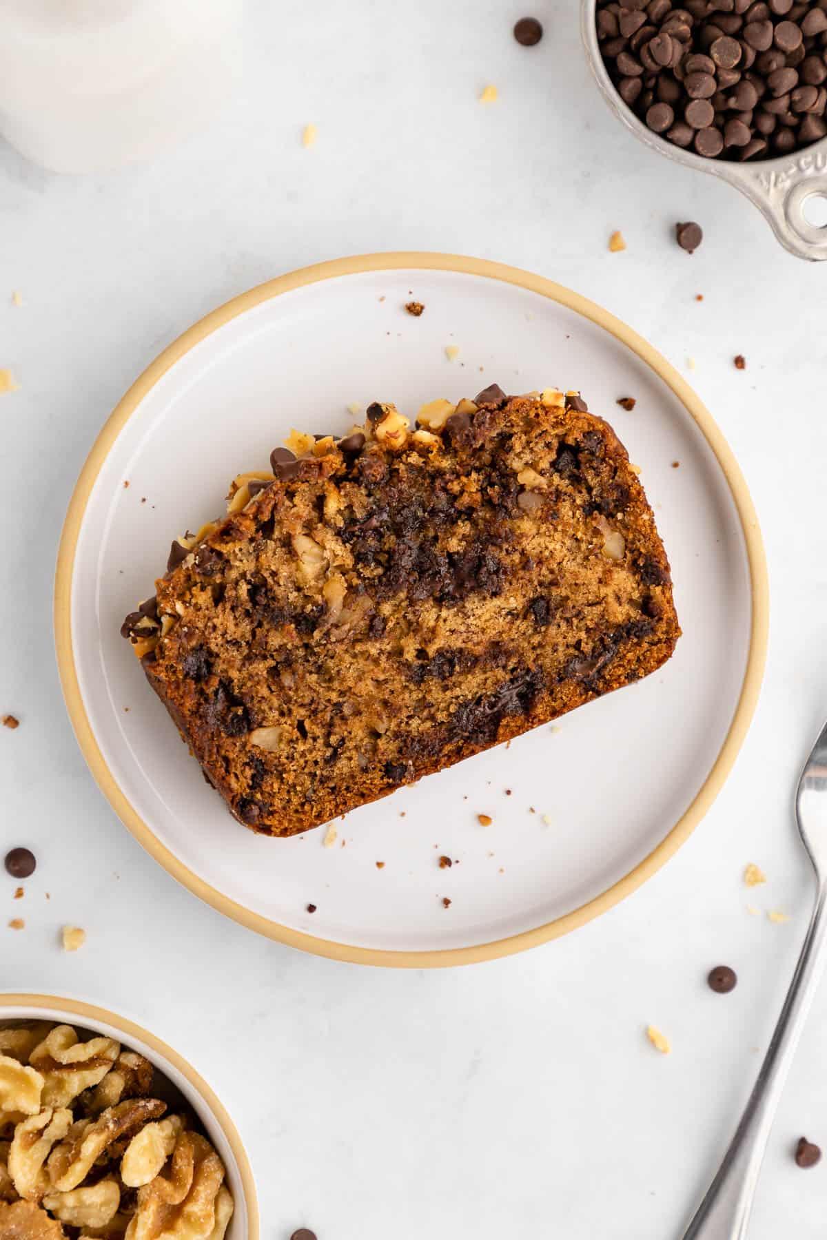 a slice of vegan chocolate chip banana bread on a ceramic plate