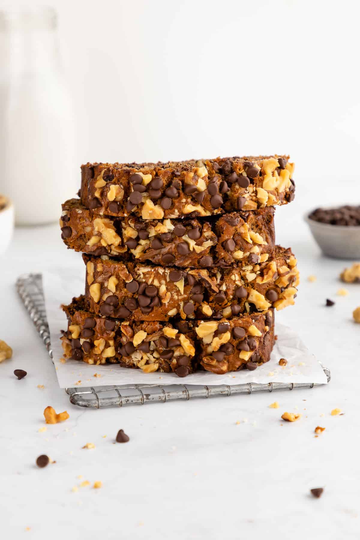 a stack of sliced vegan chocolate chip banana bread with walnuts