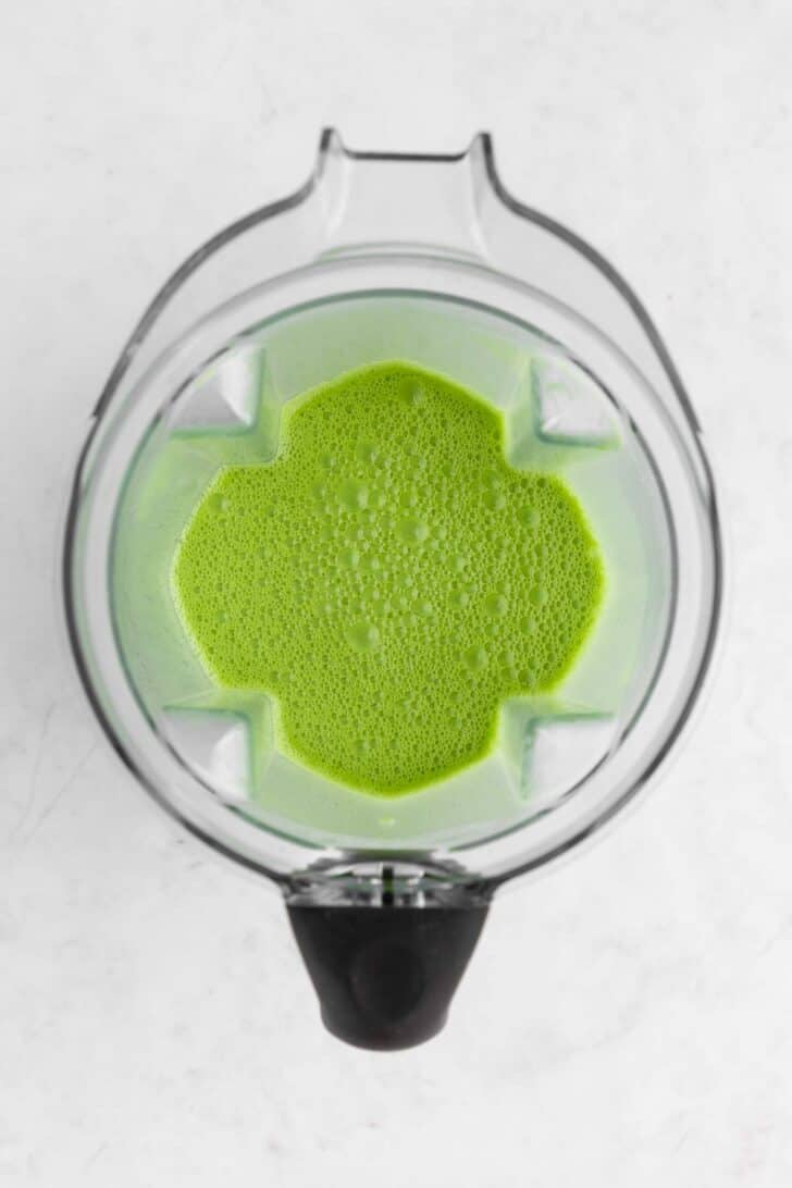 coconut milk, matcha powder, and sugar blended inside a vitamix