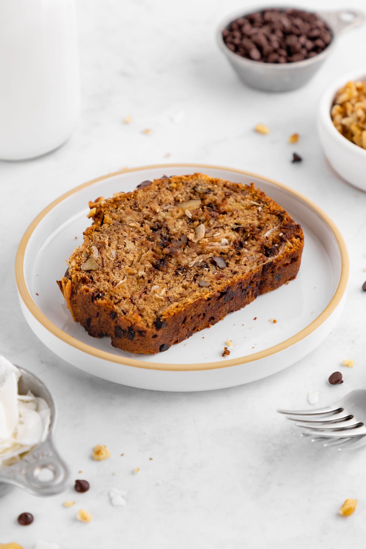 a slice of chocolate chip coconut banana bread on a plate