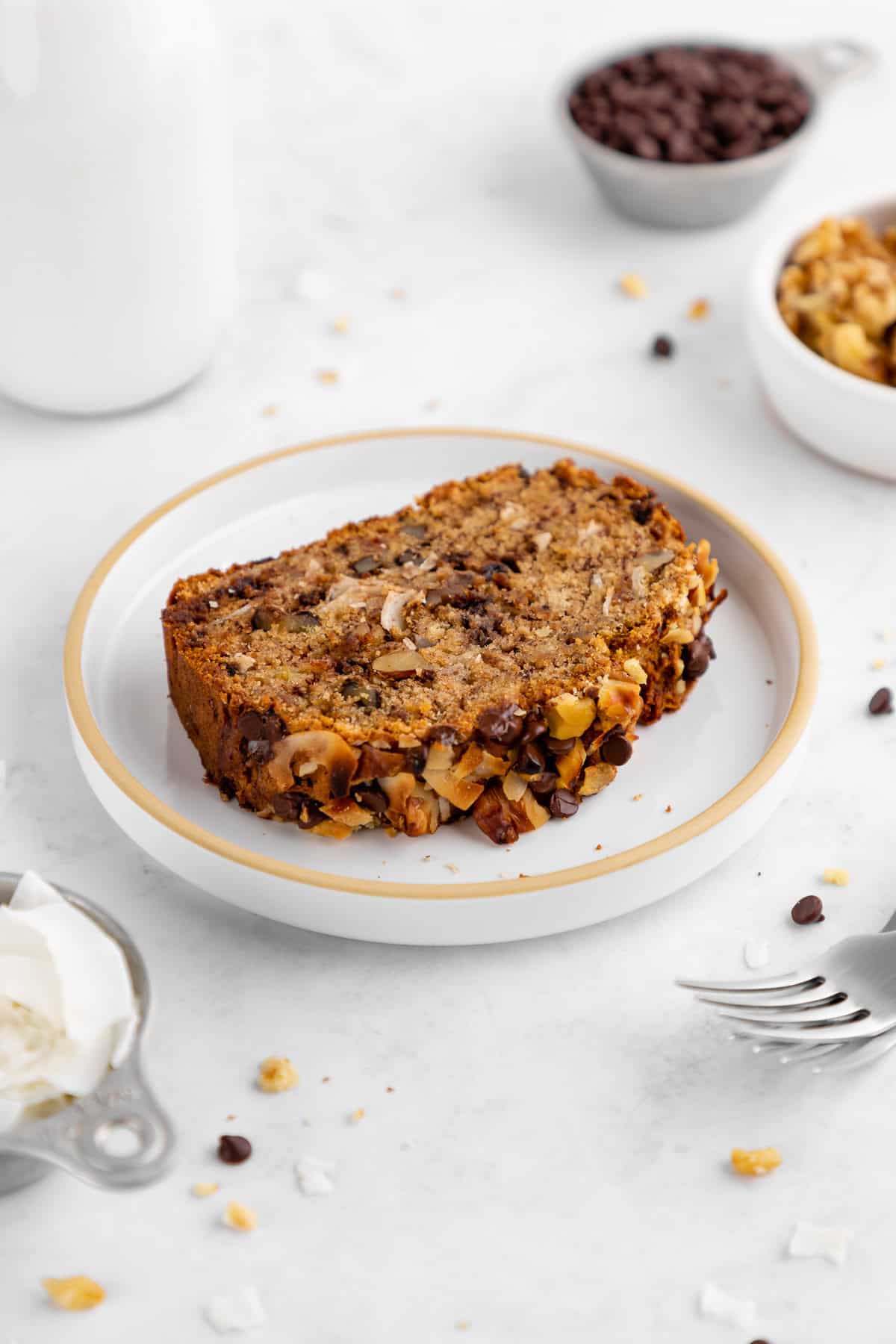 a slice of coconut chocolate chip banana bread on a plate