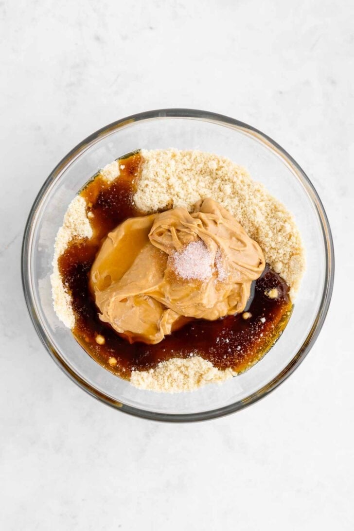 almond flour, cashew butter, maple syrup, and vanilla extract inside a glass bowl
