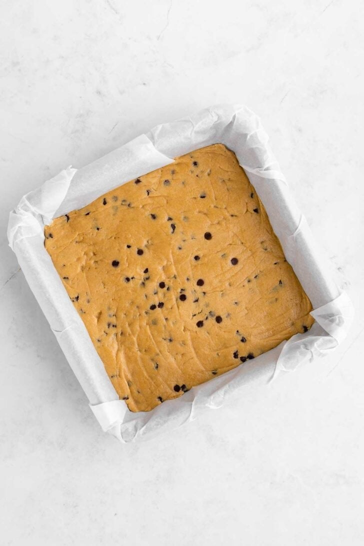 healthy edible cookie dough pressed into a square baking dish