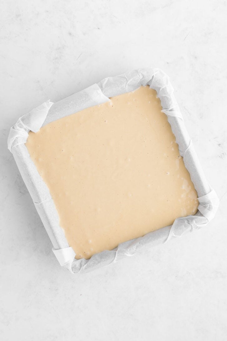 vegan no-bake cheesecake filling inside a square baking pan