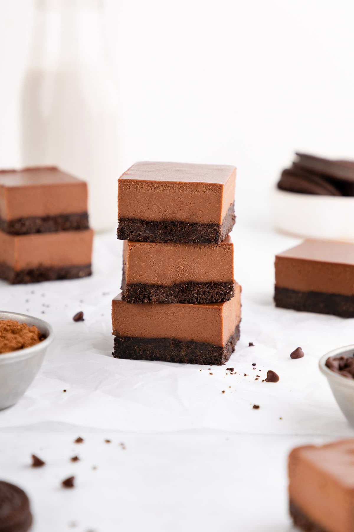 three no-bake chocolate cheesecake bars with an Oreo crust