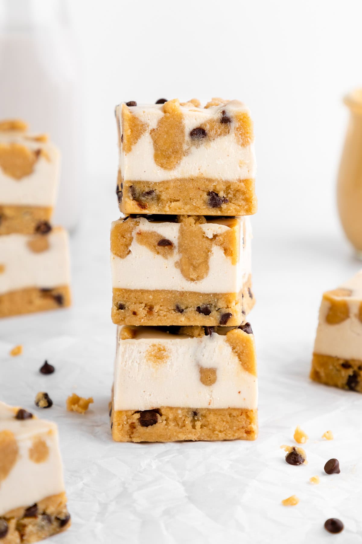 a stack of three no-bake cookie dough cheesecake bars