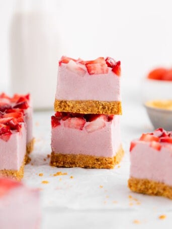 a stack of two no-bake strawberry cheesecake bars with graham cracker crust