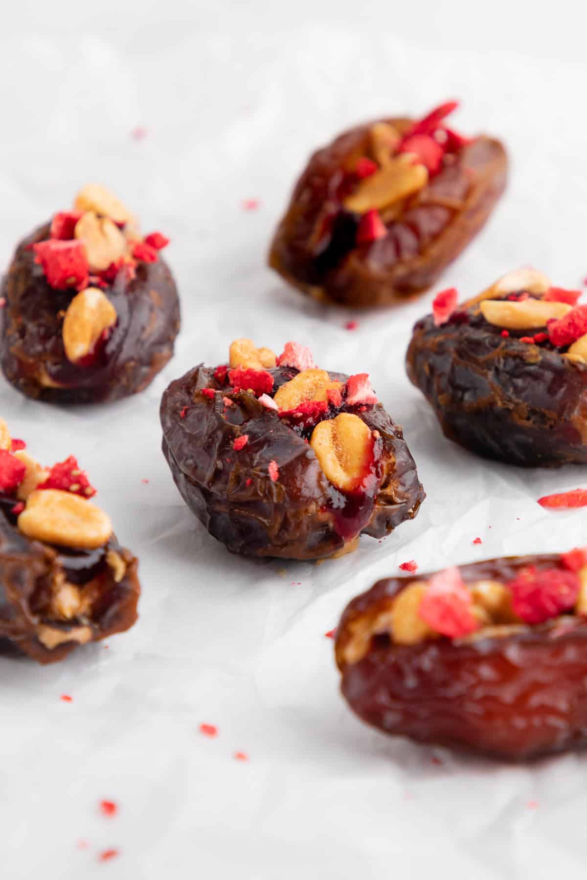 peanut butter and jelly stuffed dates with berry jam, peanuts, and freeze-dried fruit