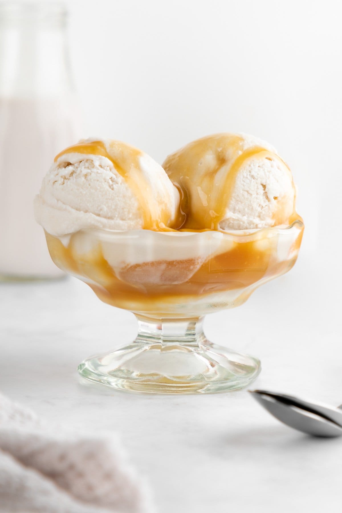 dairy-free salted caramel ice cream inside a glass sundae dish