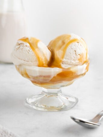 vegan salted caramel ice cream inside a glass sundae dish