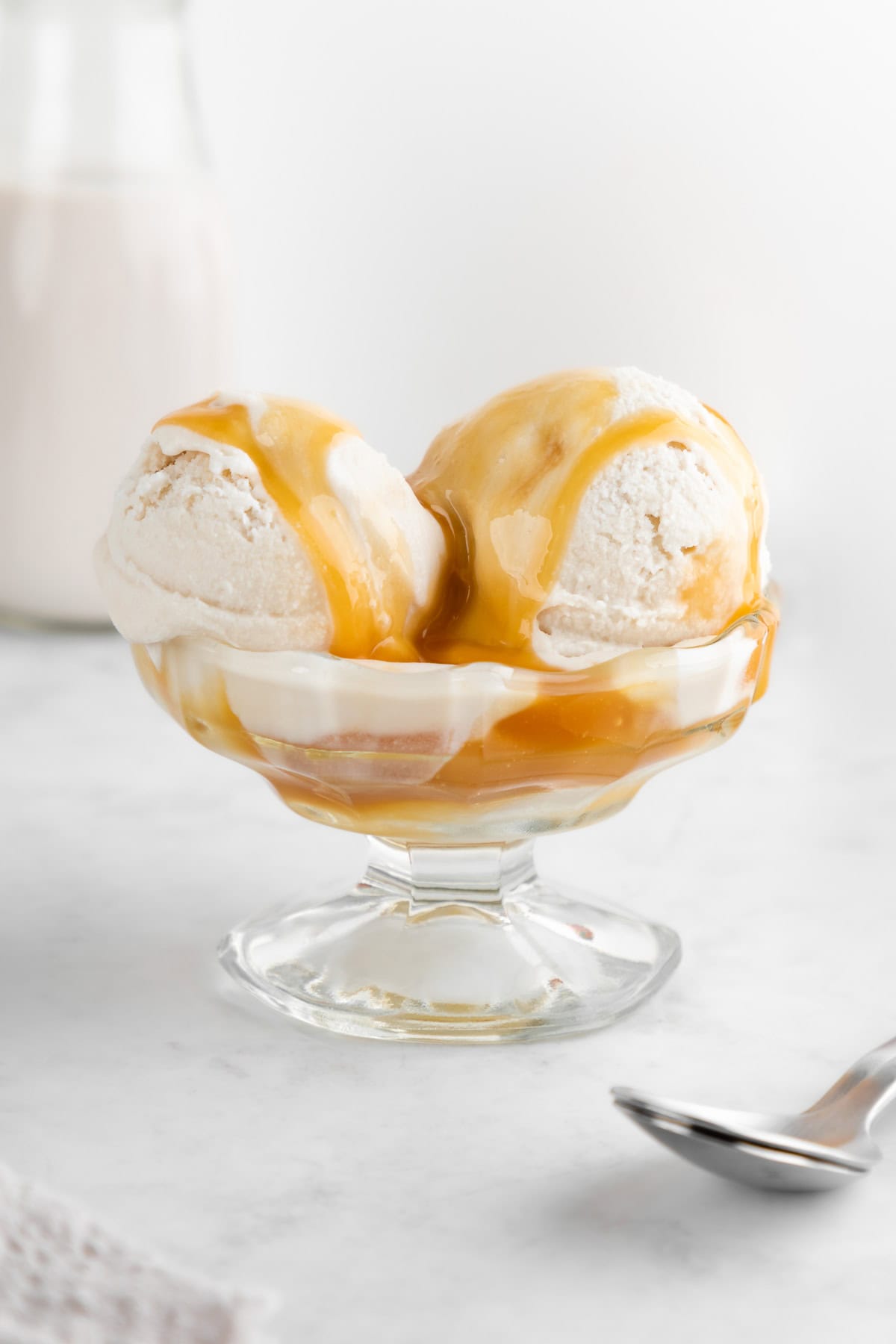 vegan salted caramel ice cream inside a glass sundae dish