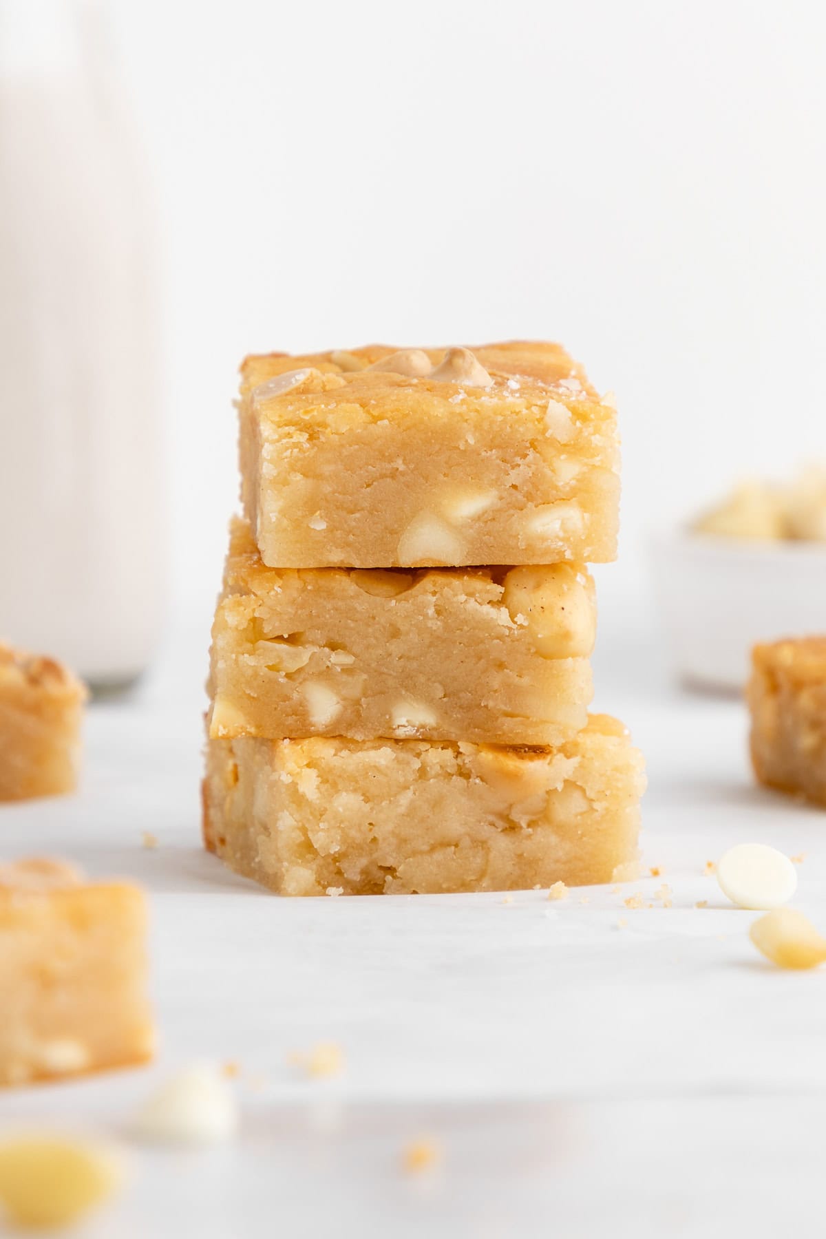 a stack of vegan white chocolate macadamia nut blondies