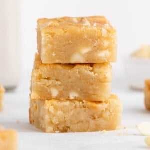 a stack of vegan white chocolate macadamia nut blondies